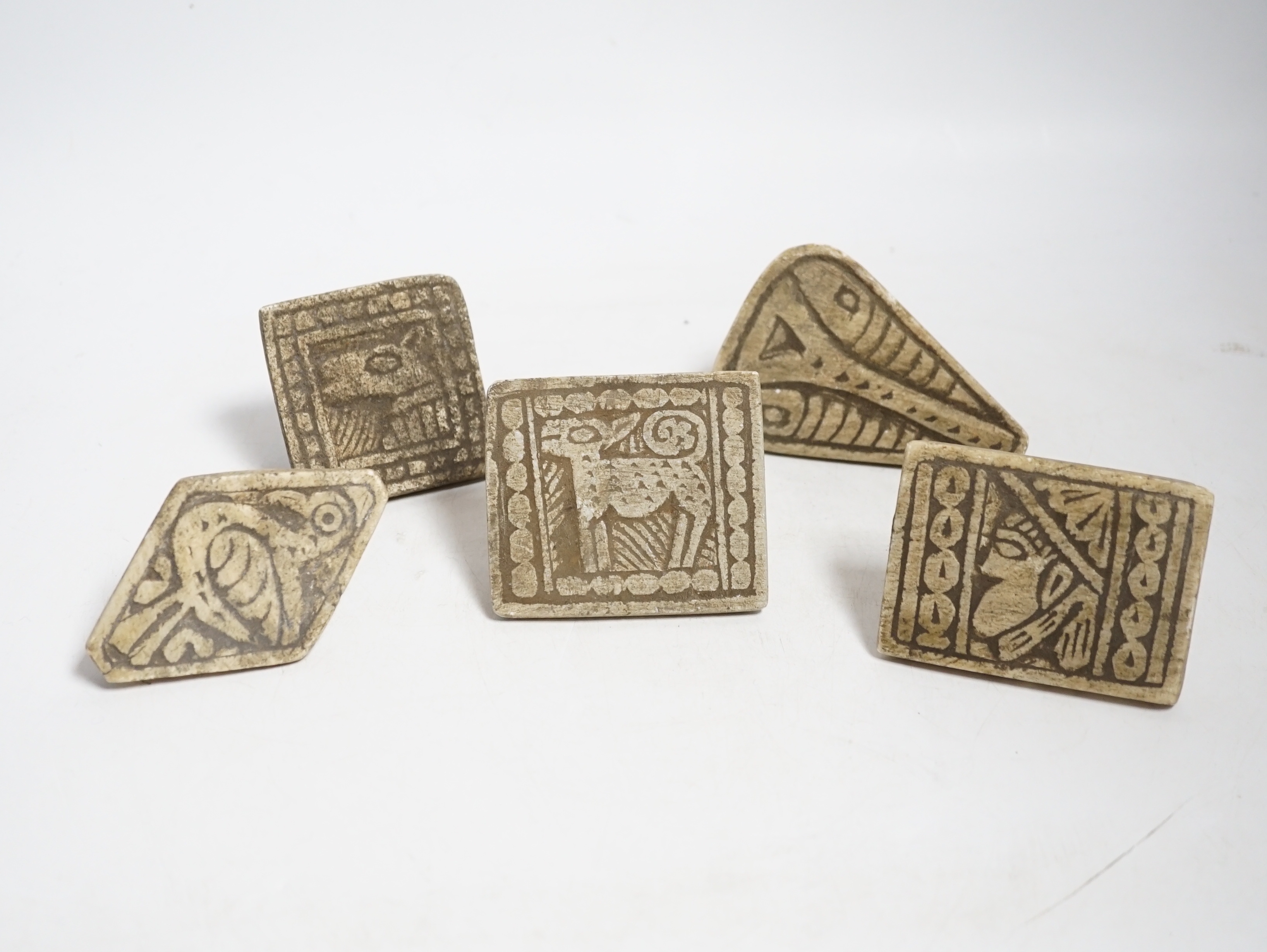 A group of five Middle eastern pottery moulds/stamps, largest, 10cm long